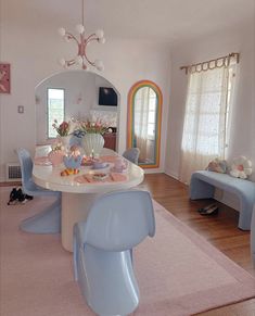 there is a dining room table and chairs in this house with pink carpet on the floor