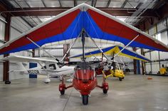 an airplane is parked in a hanger with other planes