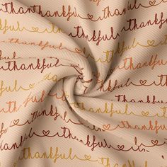 a close up view of a fabric with words on it in gold and brown colors