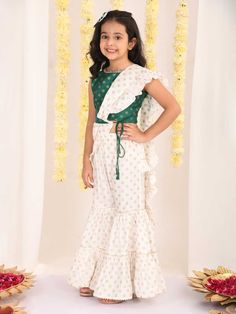 VASTRAMAY Girl's Green And Cream Palazzo Saree Set Let your little one shine in style with this adorable green and cream palazzo saree set! Featuring a printed crop top with a round neckline and border details, paired with flowy cream palazzo pants and a matching ruffled dupatta. This set is perfect for special occasions and comes complete with a cute bow hair clip. Key Features Green printed crop top with round neck and border Cream colored foil printed palazzo pants with elasticated waistband Palazzo Saree, Ruffle Dupatta, Printed Crop Top, Printed Palazzo Pants, Bow Hair Clip, Bow Hair, Green Cream, Bow Hair Clips, Cute Bows