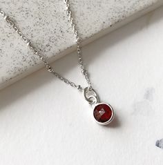 This red garnet necklace is so dainty and light. January birthstone. A small faceted gemstone pendant is set in sterling silver. The perfect crystal jewelry for everyday wear.  If you want to add more charms to your necklace, please contact me. More gemstones available here: https://www.etsy.com/ca/shop/annielesperance?ref=seller-platform-mcnav&section_id=6733458 * SIZE: 6mm stone * LENGTH: 18 inches (16 inches available on demand) * MATERIAL: Sterling silver, faceted gemstone Red Garnet Necklace, Garnet Necklace, January Birthstone, Necklace Dainty, Faceted Gemstones, Red Garnet, Crystal Jewelry, Gemstone Pendant, Sterling Silver Chains