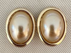 "Vintage KJL pearl cabochon clip on earrings in a gold tone frame. These signed Kenneth Jay Lane earrings feature large faux pearl cabochons and are the perfect pair to wear to work, out shopping, or a night out. Signed KJL on backs.  Great vintage condition with age appropriate wear including some surface scratches to the faux pearl cabochon.  Each measures approximately 1 1/4\" long by 15/16\" wide." Classic Cabochon Clip-on Earrings, Formal Gold Pearl Earrings Cabochon, Gold Cabochon Clip-on Earrings For Party, Katherine Graham, Cardboard Jewelry Boxes, Bamboo Earrings, Chic Gifts, Earrings Pearl, Message Jewelry