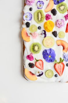 a piece of cake with fruit and flowers on it