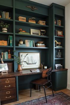 an office with bookshelves, desk and chair in front of the bookcase