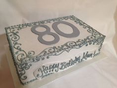 a square birthday cake with the number eighty on it's side, sitting on a white tablecloth