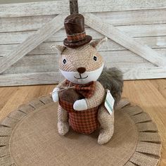 a stuffed squirrel with a top hat and bow tie