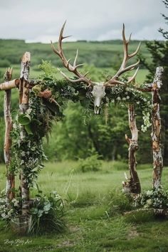 an outdoor ceremony with deer heads and greenery