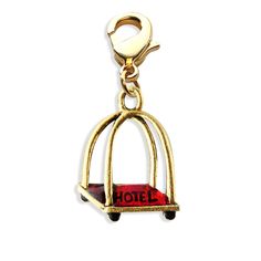 a gold charm with the word hotel on it's side and a red box in the middle