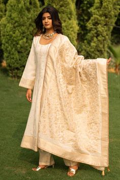 White vegan silk anarkali featuring a deep U neck and bell sleeves. Paired with a straight pant with lace work hem and a dupatta adorned with floral jaal pattern., Fit: Relaxed Silk Anarkali, White Kurta, Women Kurta, Zari Work, Lace Hem, U Neck, Straight Pants, Vintage Pattern, Aza Fashion