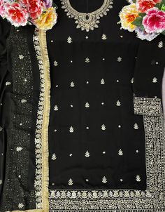 Designer Party Wear Faux Georgett Pakistani Suit Collection Processing Time : 20-25 Working Days Work : Black Floral Embroidered Georgette Pakistani Suit Fabric:Top : Faux Georgette Bottom : Santoon Dupatta : Faux Georgette Color:Top : Black Bottom : Black Dupatta : Black Note : Black colored pakistani suit is prettified with thread work as shown which makes it appear classy. This top is made of georgette fabric which is accompanied with santoon bottom, santoon lining and Georgette dupatta. Wome Black Party Wear Salwar Kameez For Festivals, Elegant Black Sharara For Festive Occasions, Elegant Black Sharara For Party, Semi-stitched Embellished Black Salwar Kameez, Black Party Wear Salwar Kameez For Eid, Black Sharara With Dupatta For Party, Party Semi-stitched Black Sharara, Fitted Bollywood Party Suits, Fitted Embroidered Pant Set For Party