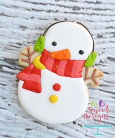 a cookie decorated like a snowman on top of a table