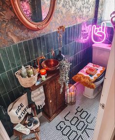 a bathroom with a sink, toilet and mirror on the wall next to a tiled floor