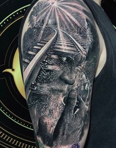 a man's arm with an elephant and train on it