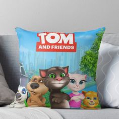 the tom and friends throw pillow is on a couch with two pillows, one has an image