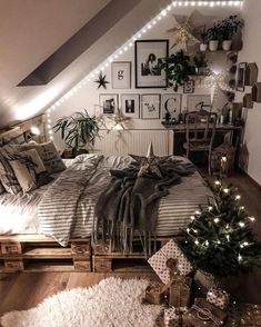 an attic bedroom decorated for christmas with lights on the ceiling and pictures above the bed