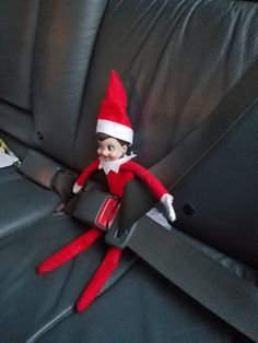 an elf is sitting in the back seat of a car with his feet on the armrest