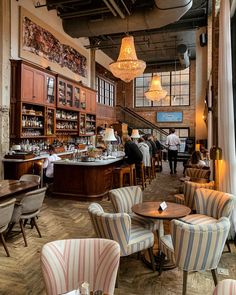 the interior of a restaurant with striped chairs