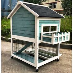 a small blue and white dog house on wheels