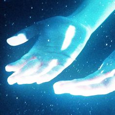 two hands reaching out to touch each other in the dark, with stars all around them