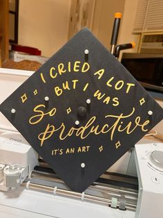 a black and gold graduation cap that says i tried alot, but was protructive it's an art