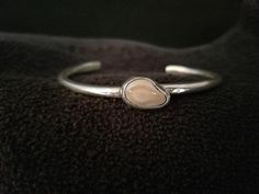 Please note that this item is made to order. The production time is about 10 days. A teardrop shape genuine elk tooth clutched in delicate sterling silver makes this a special gift. Handmade using retrieved elk ivory from Montana. Cuff size: 7" * If you would like other sizes, please choose "Anther size" from drop-down menu and put the cuff size that you would like at the box at check out says "Notes to Distinctly Montana Gifts" ** You can USE YOUR OWN IVORY at no additional cost! Yes, it's poss Elk Ivory Bracelet, Elegant Handmade Bone-colored Jewelry, Elk Ivory Necklace, Ivory Rings, Elk Ivory Ring, Elk Ivory Jewelry, Elk Ivory, Ivory Jewelry, Ivory Necklace