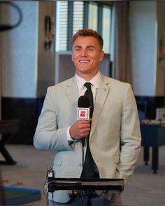 a man in a suit holding a microphone