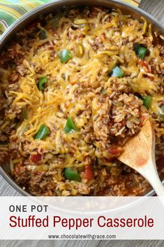 one pot stuffed pepper casserole is shown in a pan with a wooden spoon