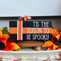 a wooden sign that says tis the season to be spooky with sunflowers