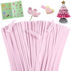 pink paper straws are lined up next to a small christmas tree and other decorations