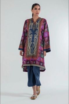 Introducing our stunning and chic two-piece kurta and pants set - a must-have addition to your wardrobe. Made from high-quality fabric, this set is designed for both comfort and style. The kurta features delicate details that add a touch of elegance to your look. The length of the kurta is just right, hitting just above the knees for a modern and sophisticated look.  The pants are designed in a straight leg style, featuring a comfortable and adjustable waistband for a perfect fit. The length is just right to complement the kurta, creating a cohesive and stylish outfit. Whether you're attending a wedding, Eid celebration, or simply want to elevate your everyday look, this set is perfect for any occasion. Pair it with your favorite accessories, shoes, and bag to create a complete look that w Multicolor Silk Straight Kurta Lawn Suit, Elegant Multicolor Lawn Suit With Dupatta, Elegant Multicolor Kurta With Resham Embroidery, Elegant Multicolor Straight Kurta, Silk Kurta With Printed Motifs, Elegant Multicolor Kurta With Printed Motifs, Elegant Multicolor Printed Motifs Kurta, Elegant Multicolor Printed Kurta, Silk Kurta Tunic With Printed Motifs