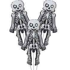 three skeleton balloons in the shape of people