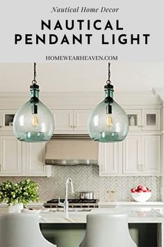 two pendant lights hanging from the ceiling in a kitchen with white cabinets and counter tops