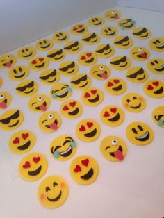 a table topped with lots of yellow emoticions on top of white counter tops