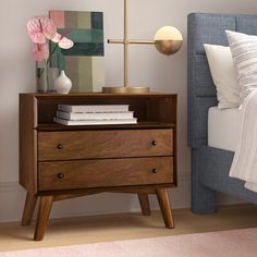 a bedroom with a bed, nightstand and flowers in vases on the bedside table