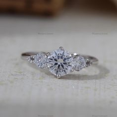 three stone engagement ring with diamond accents