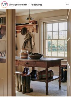 a room with a table and some boots on the floor