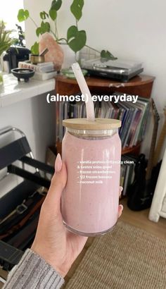 a person holding a pink smoothie with a straw in their hand that says almost every day