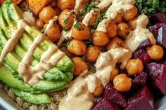 a bowl filled with different types of vegetables and sauces on top of each other