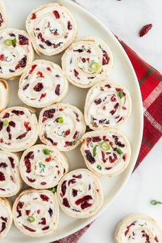 a white plate topped with mini cranberry rolls