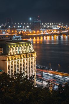 a night time view of a city and the water