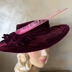 This Is Truly A Sensational Dark Burgundy Velvet Fashion Statement From The 1930s'! This Hat Is Not Stiff, But Pliable, And It Consists Of A Short, Round Crown Surrounded By A Wide Brim Which Is Slightly Curved Upwards At One Side, And Down At The Other Side. There Is A Draped Band Around The Crown That Ends In A Cascade Of Bows At One Side. From The Bows There Is A Beautiful Long Pink Feather That Compliments The Look. The Inside Of The Hat Is Finished In Pink Satin. There Is An Elastic Band Attached Inside The Hat To Keep The Hat In A Tilted Position. Women’s Hats In The 1930s Covered The Hair And Were Used To Mysteriously Cover One Eye Or The Forehead. The Front Brim Could Be Floppy O Elegant Burgundy Brimmed Hat, Elegant Pink Hat With Feather Trim, Vintage Red Felt Hat With Curved Brim, Vintage Wide Brim Pink Hat, Vintage Hat With Feather Trim And Curved Brim, 1930s Hats, Dark Burgundy, Wide Brim Fedora, Burgundy Velvet