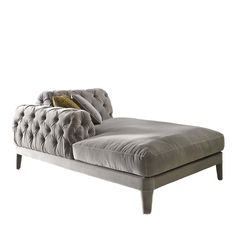 a gray chaise lounger with pillows on it