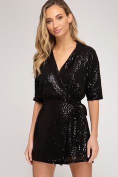 Own your girls’ night with the right amount of sparkle. The Soul Train Romper is a 3/4 sleeve romper with a wrap-over bodice with tie, collared plunging V neckline, and sequined fabric, giving movement and glimmer to the outfit. Rock this party look with a pair of sparkly dangling earrings and matching black heels to keep all eyes on you. Black Sequin Romper, Glitter Romper, Soul Train, Nye Outfits, Sequin Rompers, Heels Outfits, Wrap Romper, Surplice Neckline