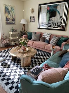 a living room filled with lots of furniture and decor on top of a checkered rug