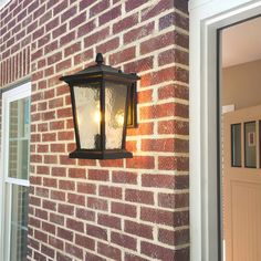 a light on the side of a brick building