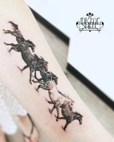 a horse tattoo on the arm with four horses running in it's tracks,