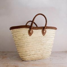 This bag is handwoven in the souks of Morocco, from a palm leaf. It is a "Slow Fashion" product representing everything that is eco, ethical and green. Even though this Spring & Summer season is all about straw. Small round wicker French basket, hand woven in Marrakesh by friends and family. Ideal small shopper or beach bag. Also a perfect bag or gift for a girl - great for school books etc. This braided bag is perfect anytime and everywhere, Especially in the summer and there are those who like Market Basket Straw Bag With Leather Handles, Brown Palm Leaf Bag For The Market, Brown Palm Leaf Bag For Market, Brown Palm Leaf Straw Basket Bag, Brown Palm Leaf Basket Straw Bag, Brown Basket-shaped Palm Leaf Straw Bag, Brown Palm Leaf Bucket Beach Bag, Woven Leather Basket Straw Bag For Market, Fair Trade Basket-shaped Straw Bag For Market