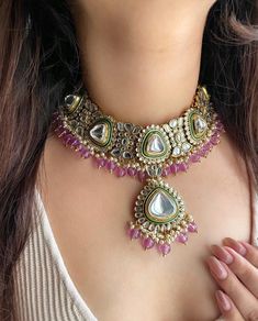 Adorn yourself in timeless elegance with this exquisite lavender purple Kundan and zircon necklace set, perfect for weddings and special occasions. Crafted with meticulous attention to detail, the set features delicate  hues reminiscent of Pakistani and Punjabi traditions, with a touch of Bollywood glamour. Complete with matching earrings and a stunning maangtika, this Indian Kundan ensemble effortlessly captures the essence of sophistication and grace. Measurements:   Necklace Length-14" Necklace Width- 11" Centre piece length -4" Earring Length-4" Each earring weighs:54 gms    Maangtika Length- 7" Maangtika Width- 1.5" Elegant Purple Kundan Necklace For Festive Occasions, Elegant Purple Kundan Necklace As Gift, Elegant Purple Kundan Necklace For Wedding, Elegant Purple Meenakari Jewelry, Purple Diamond Necklace For Wedding, Purple Diamond Necklaces For Wedding, Purple Necklaces With Intricate Design For Wedding, Purple Wedding Necklace With Intricate Design, Purple Wedding Necklaces With Intricate Design