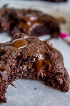 two chocolate cookies with one broken in half