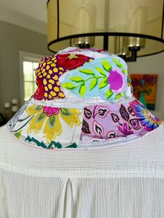 Super cute up-cycled floral bohemian, hippie, patchwork hat. This hat will take you everywhere! Whether you're golfing, gardening, boating, beach day, dancing at a festival or just chillin fishing, this is going to be your go to hat. I have made many and they are machine washable, that's is how you get them to FRAY! However, they will shrink a bit as the are 90% cotton. So best to hand wash and line dry. The circumference is 22.8inch. Foldable, easy to carry or pack inside your purse, tote or backpack. 90% Cotton, 10% Poly Hand wash gentle cycle and Line dry Multicolor Patchwork Casual Hat, Casual Multicolor Patchwork Hat, Bohemian Adjustable Sun Hat For Garden Party, Adjustable Bohemian Sun Hat For Garden Party, Reversible Multicolor Cotton Sun Hat, Multicolor Reversible Cotton Sun Hat, Pink Bohemian Sun Hat For Garden Party, Bohemian Pink Sun Hat For Garden Party, Bohemian Pink Bucket Hat For Vacation